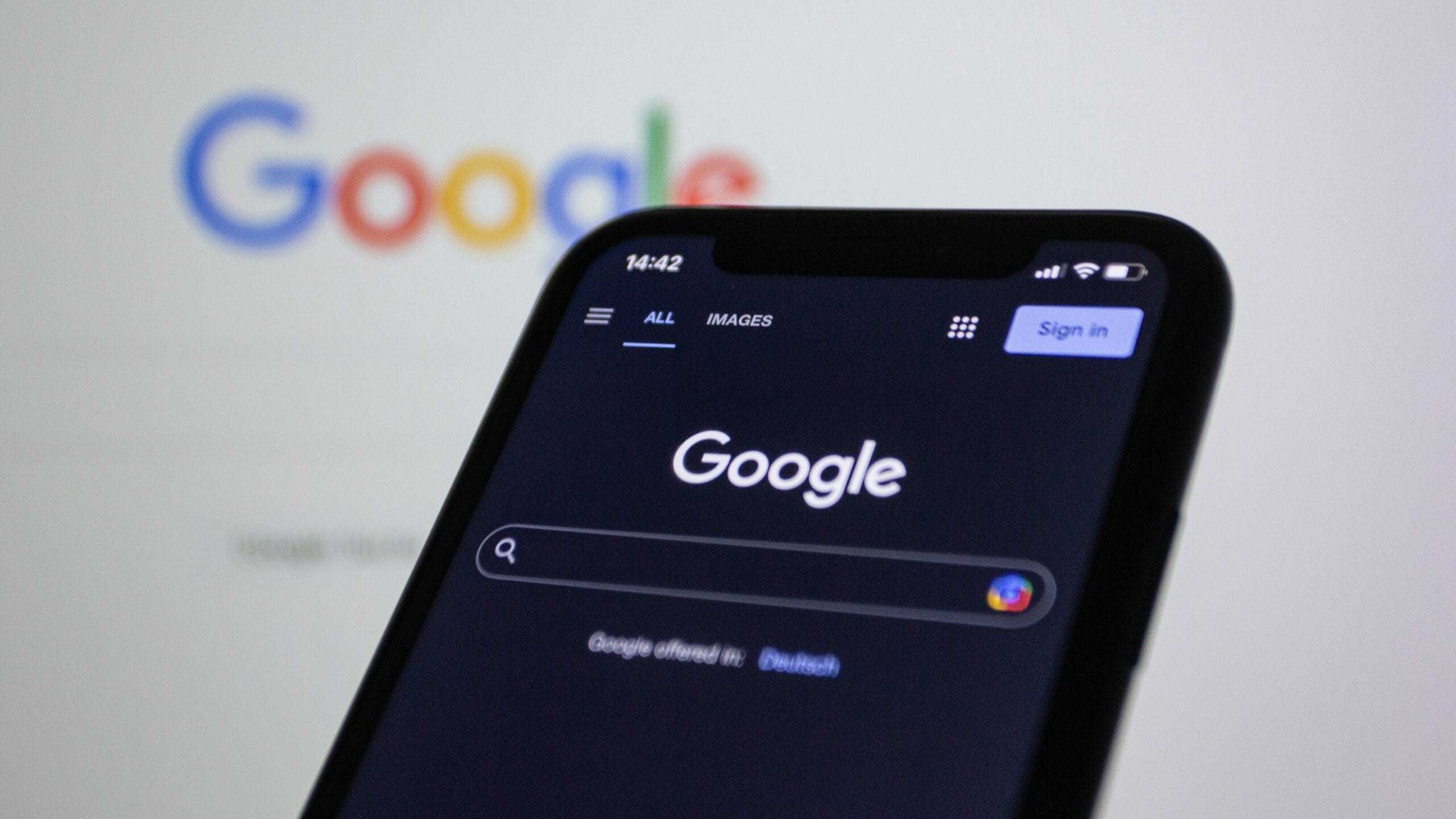 google search engine optimization on mobile with a desktop background